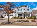 Charming two-story home with welcoming front porch, beautiful landscaping, and two-car garage at 2172 Paddlers Cove Dr, Clover, SC 29710