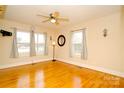 Cozy bedroom boasting hardwood floors, a ceiling fan, and ample natural light from multiple windows at 3039 N Center St # 10/C, Hickory, NC 28601