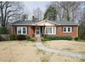 Quaint brick home with gray shutters, a well-kept lawn, and a welcoming front porch at 3039 N Center St # 10/C, Hickory, NC 28601