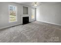 Spacious living room featuring a fireplace, neutral walls, plush carpet, and abundant natural light at 3450 Seminole Dr, Maiden, NC 28650