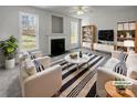 Bright living room featuring a fireplace, a striped rug, neutral furnishings, and lots of natural light at 3450 Seminole Dr, Maiden, NC 28650