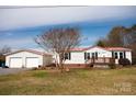 Charming home featuring a detached two-car garage and inviting front porch at 3991 Bunker Hill School Rd, Claremont, NC 28610