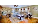 Spacious living room with hardwood floors, stylish rug, and comfortable sectional sofa at 401 N Inman Ave, Bessemer City, NC 28016