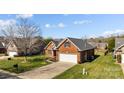 Charming brick home with a well-maintained lawn and a spacious driveway at 4405 Zee Ct, Monroe, NC 28110