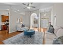 Bright and airy living room featuring hardwood floors, white furniture, and a blue ottoman at 4405 Zee Ct, Monroe, NC 28110