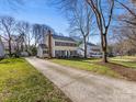 Expansive view of this two story home showing the long driveway and large yard at 605 Heathermoor Ct, Charlotte, NC 28209