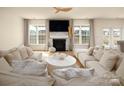 Spacious living room with hardwood floors, fireplace, large windows, and a cozy seating arrangement at 611 Yucatan Dr, Waxhaw, NC 28173