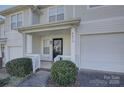 Inviting front porch with covered entrance, white railing, and a cozy, welcoming feel at 6672 Vlosi Dr, Charlotte, NC 28226