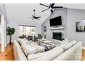 Bright living room with a painted brick fireplace and hardwood flooring at 9307 Raintree Ln, Charlotte, NC 28277