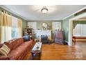 Charming living room featuring hardwood floors, a decorative fireplace, and vintage accents, creating a cozy ambiance at 940 N New Hope Rd, Gastonia, NC 28054