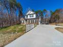 Inviting home featuring a long driveway and white picket fence at 1004 Loganberry Ln, Salisbury, NC 28146