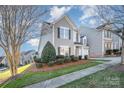 Well-maintained two-story home with neat landscaping, visible from the sidewalk at 10142 Linksland Dr, Huntersville, NC 28078