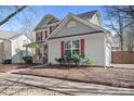 Attractive home with red shutters, well-maintained landscaping, and attached garage at 13206 Meadowmere Rd, Huntersville, NC 28078