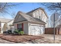 A single car garage in a beautiful home with red shutters and green bushes at 13206 Meadowmere Rd, Huntersville, NC 28078