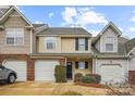 View of a townhome featuring neutral siding, a brick accent, and an attached garage at 1386 Walnut Hill Dr, Rock Hill, SC 29732