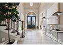 Grand foyer featuring tile floors, staircase, an arched doorway, and modern decor at 145 Milford Cir, Mooresville, NC 28117