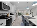 Gourmet kitchen boasts stainless steel appliances, subway tile backsplash, and a marble countertop island at 201 Bennett Trail Dr, Mount Holly, NC 28120