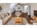 Bright living room with hardwood floors, ceiling fan, neutral paint and lots of space for entertaining at 205 Mauney St, Mount Holly, NC 28120