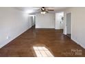 Spacious living room showcasing hardwood floors, neutral paint, and bright natural light at 205 Mauney St, Mount Holly, NC 28120