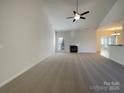 Spacious living room featuring a fireplace, neutral carpet and a view into the dining area at 235 Glenville Dr, Fort Mill, SC 29715