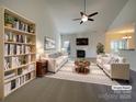Bright living room showcasing a fireplace, vaulted ceiling, and stylish furnishings at 235 Glenville Dr, Fort Mill, SC 29715