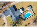 An overhead view reveals a home with a backyard swimming pool, patio area, and a neatly kept lawn surrounded by foliage at 2659 Surrey Dr, Lincolnton, NC 28092