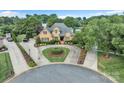 Beautiful brick home with circular driveway and lush landscaping in a well-established neighborhood at 3759 Sand Wedge Dr, Gastonia, NC 28056