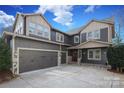 Charming home featuring a two-car garage, stone accents, and a covered front porch at 4124 Sherbrooke Dr, Charlotte, NC 28210