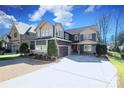 Stunning exterior showcasing a spacious driveway, manicured lawn, and a two-car garage at 4124 Sherbrooke Dr, Charlotte, NC 28210