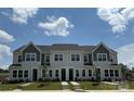 Charming two-story townhomes featuring classic architecture and a well-manicured lawn at 4714 Lakeview Rd # 11, Charlotte, NC 28216