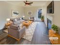 Bright living room features a fireplace, large window, and neutral tones, perfect for relaxation at 4922 Windchase Ln, Charlotte, NC 28269