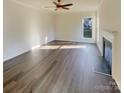 Bright living room features a fireplace, large window, and neutral tones, perfect for relaxation at 4922 Windchase Ln, Charlotte, NC 28269