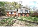 View of the home showing the lawn and a two-story home with brick and vinyl siding at 6126 Eagle Peak Dr, Charlotte, NC 28214