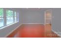 An empty living room featuring beautiful floors and light blue walls with large window at 6126 Eagle Peak Dr, Charlotte, NC 28214