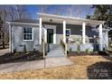 Beautiful brick home with a welcoming covered porch, updated landscaping, and modern finishes at 6813 Elm Forest Dr, Charlotte, NC 28212
