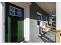 Lovely porch view with a welcoming green door, seating, and great curb appeal at 6813 Elm Forest Dr, Charlotte, NC 28212