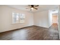 Bright bedroom with hardwood floors, a ceiling fan, and natural light from a large window at 735 Green St, Rock Hill, SC 29730