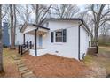 Side view of painted brick house, black trim, covered porch, and stone pathway to the front door at 735 Green St, Rock Hill, SC 29730