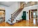 Bright foyer with hardwood floors, staircase, and bench seating at 7921 Altacrest Dr, Concord, NC 28027