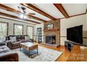 Comfortable living room with hardwood floors, brick fireplace and leather sofa at 7921 Altacrest Dr, Concord, NC 28027
