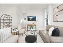 Bright living room showcasing neutral tones, hardwood floors, modern furniture and a mounted television at 921 Park Dr, Statesville, NC 28677