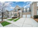 Charming townhome featuring a brick facade, balcony, two-car garage and manicured lawn at 10349 Linksland Dr, Huntersville, NC 28078
