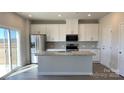 Bright kitchen featuring white cabinets, stainless steel appliances, and a center island at 1102 Harry Ct, Albemarle, NC 28001