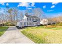 Charming two-story home featuring a well-manicured lawn, newly mulched beds, and classic architectural details at 1133 Bloom Wood Ln, Matthews, NC 28105
