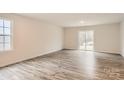 Bright living room boasts wood-look flooring and sliding glass doors to the outside at 116 Dorian Pl, Troutman, NC 28166