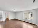Spacious living room with hardwood floors and ample natural light from the large windows at 1249 Shenandoah Cir, Rock Hill, SC 29730