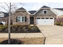 Charming stone and siding exterior with a two-car garage and beautifully landscaped front yard at 12609 Twilight Dr, Mint Hill, NC 28227