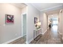 Inviting hallway with wood floors and neutral tones, leading to various rooms at 12609 Twilight Dr, Mint Hill, NC 28227