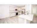Bright kitchen features stainless appliances, granite counters, and white cabinets at 171 Meadowlark Ln, Statesville, NC 28625