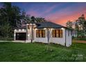 Inviting one-story home with modern design, black framed windows, and manicured front lawn at 17201 Green Hill Rd, Charlotte, NC 28278